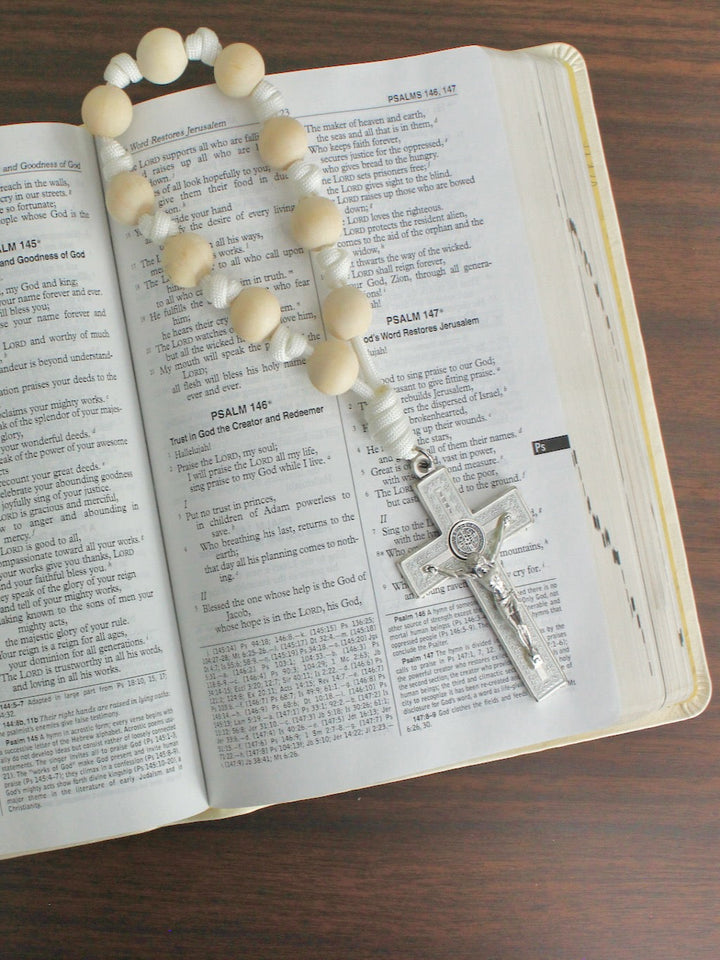 Handmade one decade door rosary by Knots of Grace, Divine Peace St. Benedict Door Rosary, white (pictured on bible)