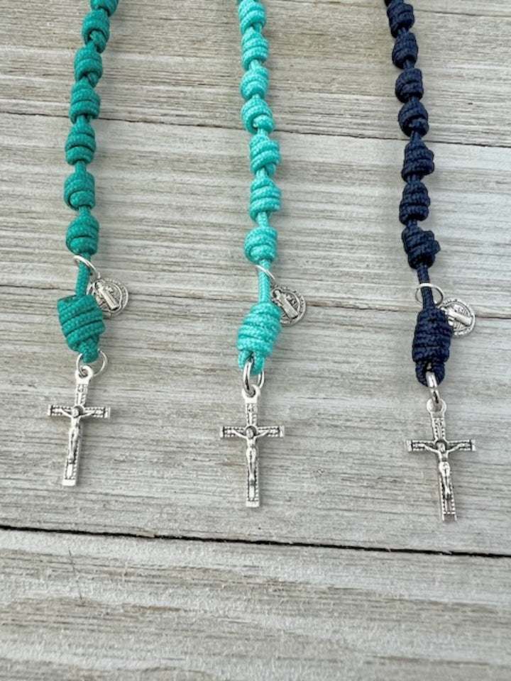 Close-up of Knots of Grace handmade one-decade Tiny Traveler pocket rosaries in teal, turquoise, and navy cord